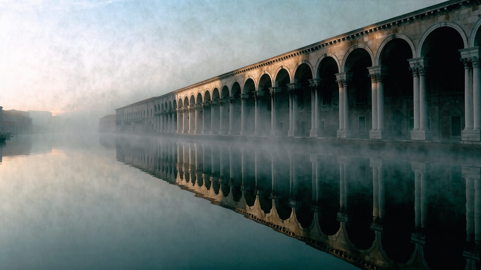 The Fabbriche Nuove receding into dawn fog along the Grand Canal.